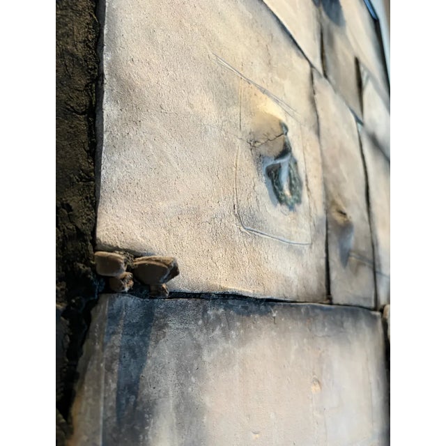 Striking geometric raku-fired clay tile wall sculpture, professionally mounted and framed in a sleek black frame. This...
