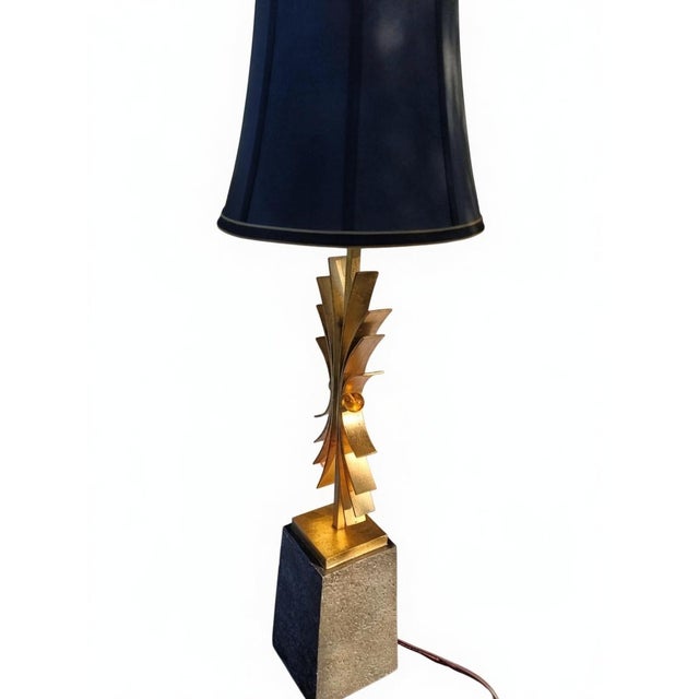 Striking Mid-Century Modern sculptural table lamp featuring a dramatic gold-tone metal starburst / sunburst design with...