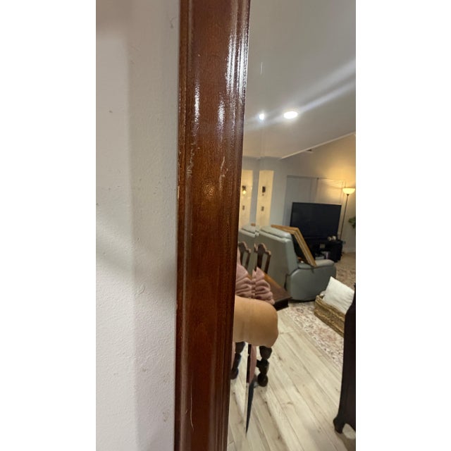 This mirror displays the classic Chippendale style, characterized by its ornate, scrolled mahogany frame with distinct...