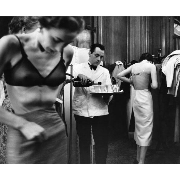 Backstage At a fashion show in France, John Cavanagh's models change backstage as a waiter pours champagne. Original...
