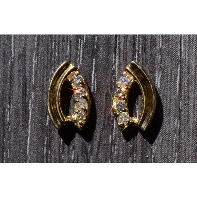 The Oakley: Yellow Gold Diamond Wishbone Style Earrings. The earrings are set with a row of round brilliant cut natural...