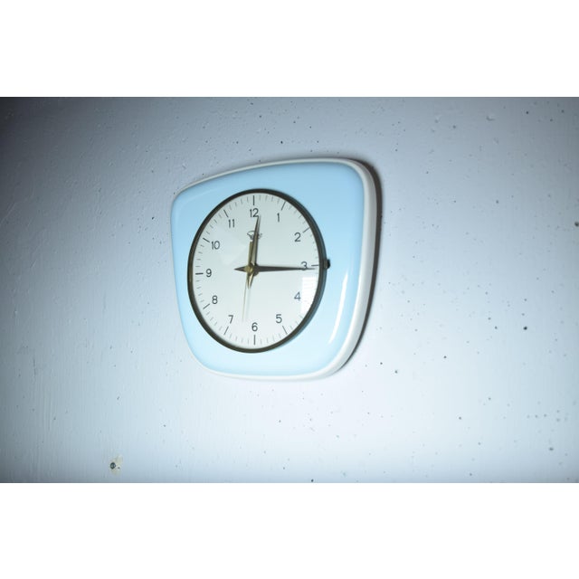 This is an original selva kitchen clock from the 1950s. the case is made of enamel in a soft pastel light blue. it has the...