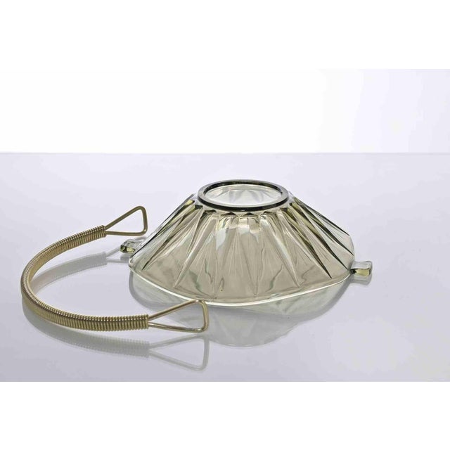 Vintage glass basket is a vintage object realized in 1950s. Art glass and iron. Very good conditions