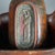 An antique Chinese lidded basket offers wood polychromed wood construction with foliate decoration and figure of a man...