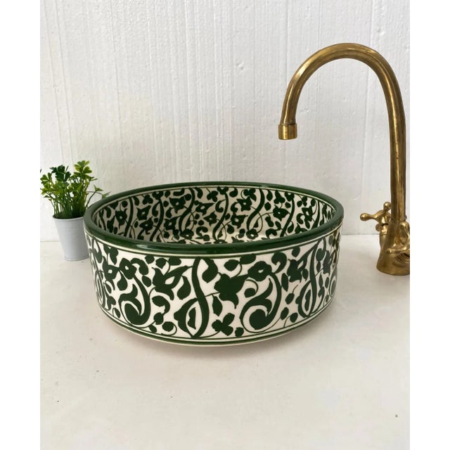 The handcrafted Charlotte' basin features an intricate floral pattern of GreenWith dominated Pure White. It takes...