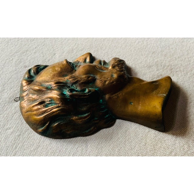 …. A striking mid-century cast heavy copper bas-relief portrait plaque depicting a classic, highly detailed profile of...