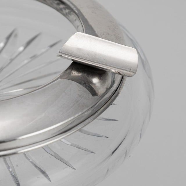Vintage 20th Century silver plated & cut glass ashtray, featuring a naval badge decoration on the front. The rim is also...