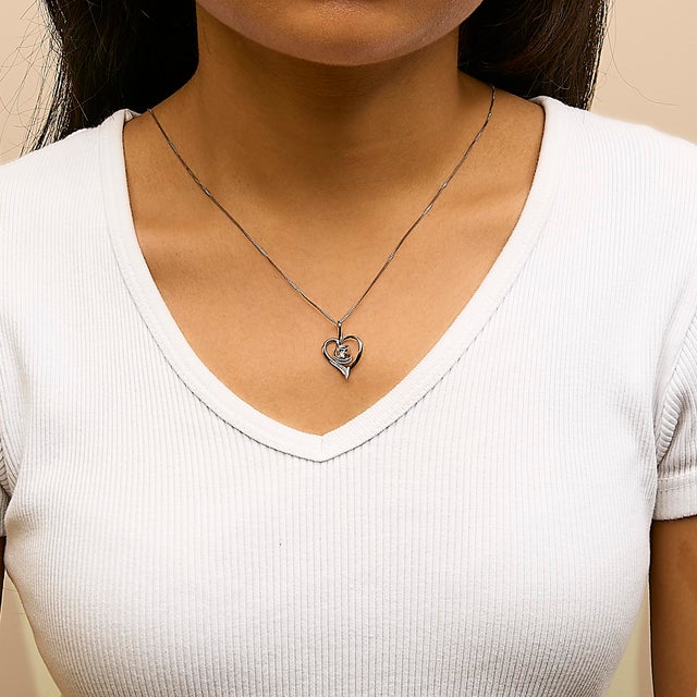 Symbolizing a love that never ends, this impeccably designed real 10kt gold heart pendant swirls at the center and...