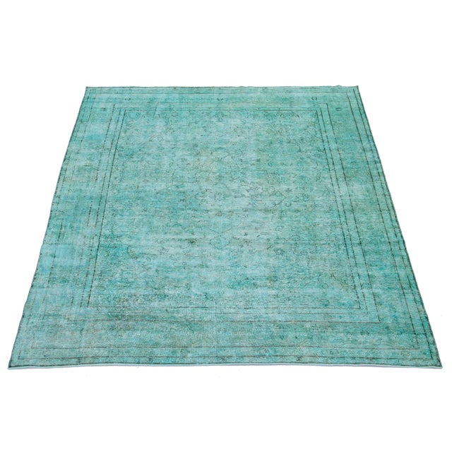 This is an antique hand-knotted wool Persian rug with a Turquoise field. It features an all-over floral design with gray...