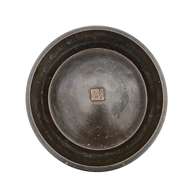 An exceptional antique Chinese bronze tripod narcissus basin (shuipen) dating to the Qing Dynasty (19th Century). Highly...