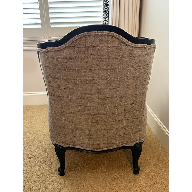 Updated Louis XV bergere chair. Painted Navy blue carved frame and newly upholstered in highland house fabric. Comfortable...