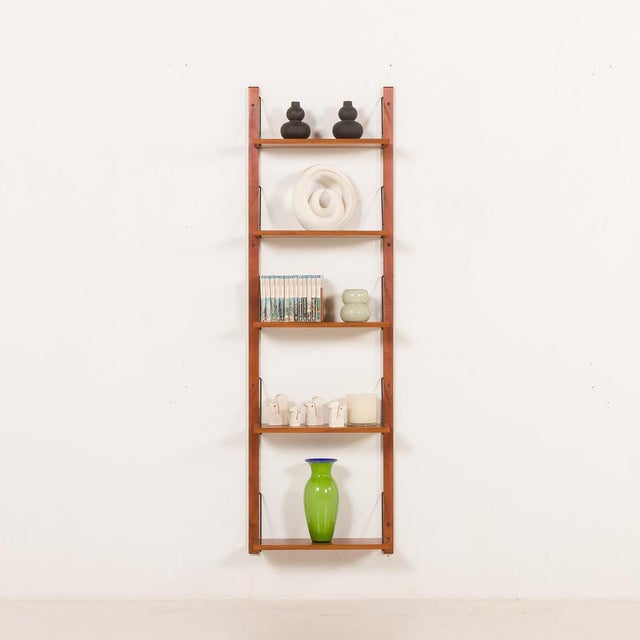 Wall-mounted shelving unit in solid teak, designed in the mid-century modern style and rebuilt through an upcycling...