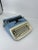 Vintage Mid Century Royal Aristocrat portable typewriter. Features a bright blue color body with creamy white keys and...