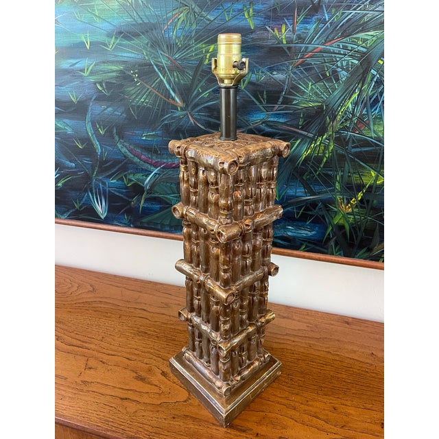 Vintage faux bamboo column table lamp featuring a stacked bamboo motif and warm antiqued bronze finish. The sculptural...