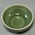 This antique Chinese Longquan celadon cup has a smooth rounded body, covered in rich olive-green glaze with natural...