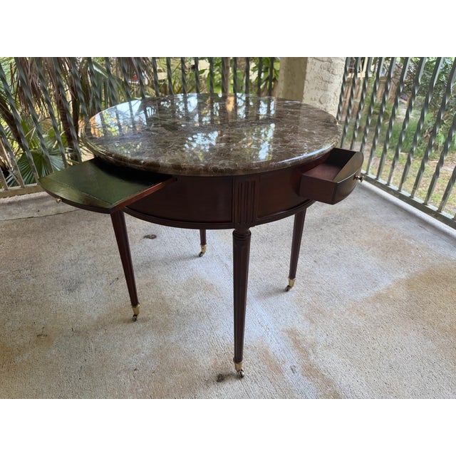 Biltmore Estate Collection Lamp Table crafted in mahogany with a marble top. It features two drawers on each side with...