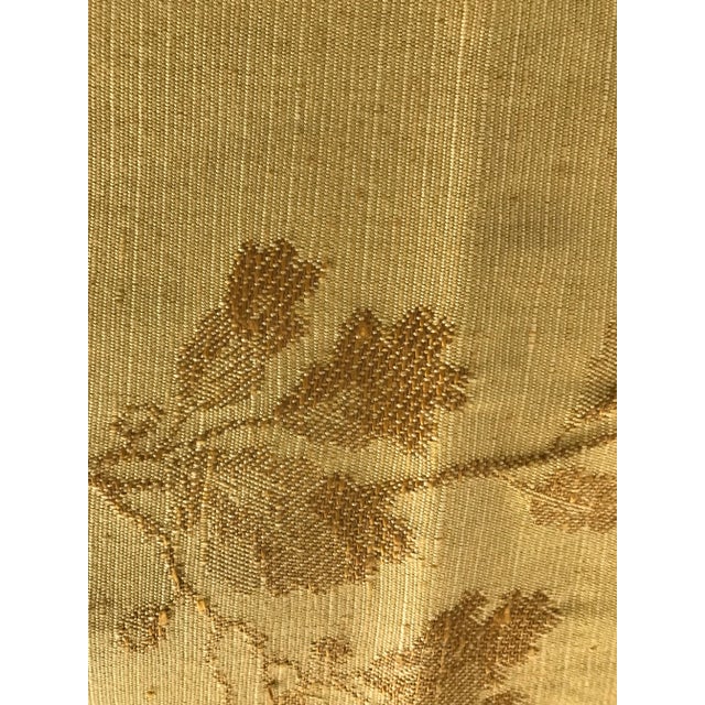A lovely piece of woven fabric with a vertical leaf branch detail. Shades of gold.