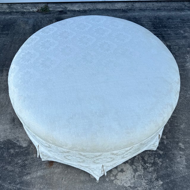 Custom upholstered ivory damask round ottoman with tailored skirt. Great in a dressing room or living room.
