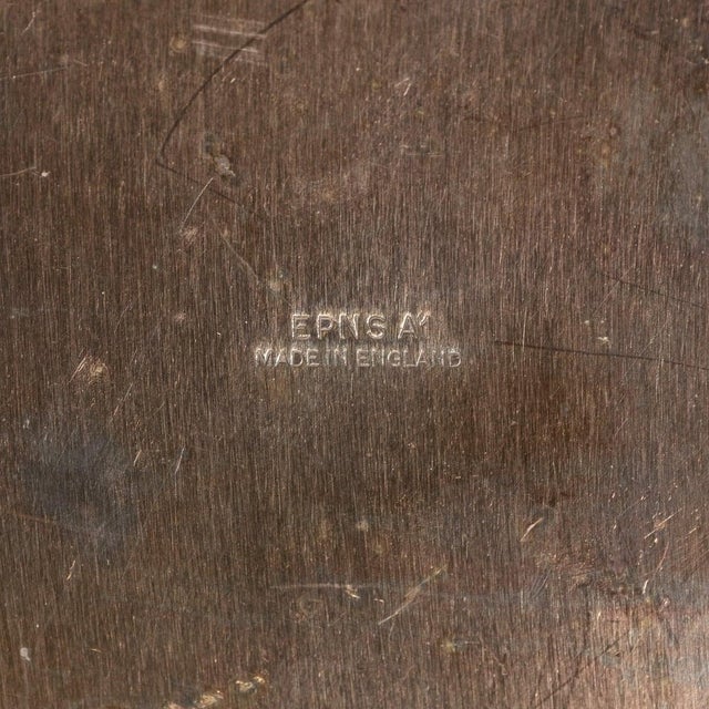 An early 20th Century ice bucket on stand made in England. Its plain looped handles, straight lines and tapered body gives...