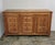 A striking oak credenza in the Spanish Revival style, dating from the mid-20th century. The paneled front is richly...