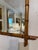This is a French antique faux-bamboo wall mirror with a beveled glass and hand-carved wood frame. The frame is wood that...