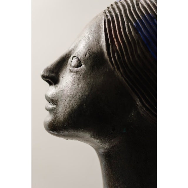 Half-length terracotta sculpture of an Ethiopian woman by Gino Zattoni from the 1950s. The sculpture depicts a young woman...