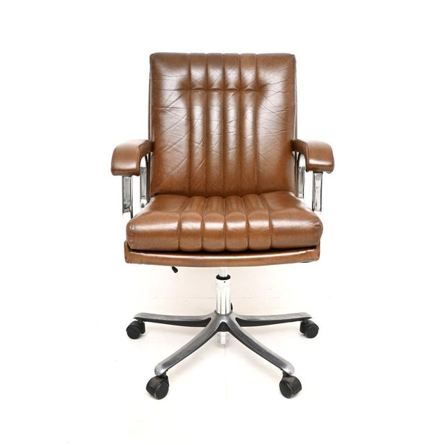 A smart and extremely comfortable vintage leather and chrome swivel desk chair. This was made in England by Verco, it...