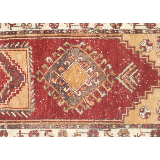 Handwoven vintage Turkish Oushak runner measuring 2'9" x 9'4". Crafted with wool on wool foundation in Western Turkey's...