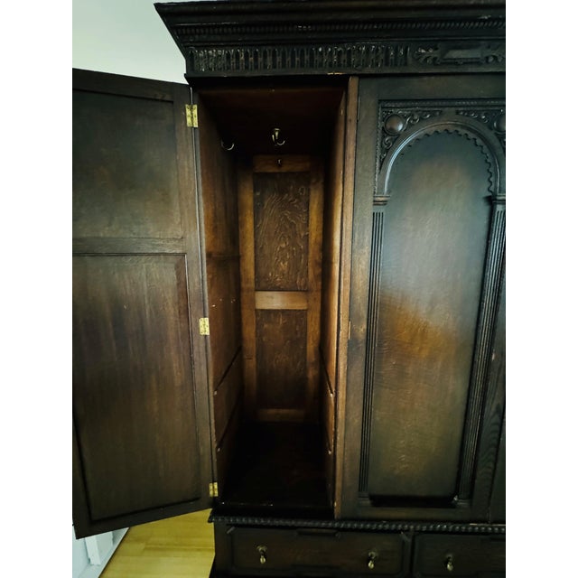 Crafted in the early 20th century, this exquisite Jacobean style wardrobe is fashioned from solid quarter sawn English...