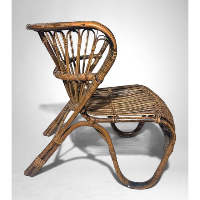 Charming lounge chair crafted from natural rattan and wicker, embodying the refined organic aesthetic that defined...