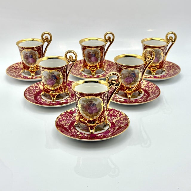 Vintage Limoges porcelain coffee set of 13 pieces, decorated with romantic Fragonard courting couple scenes, set against a...