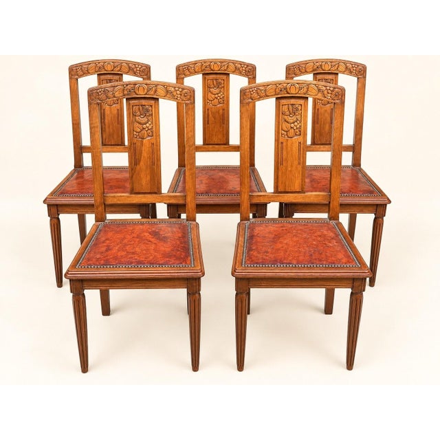 A set of five art deco dining chairs in solid walnut, likely dating from the 1920s or 1930s. the open back reveals a...