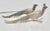 A matched pair of male and female pheasants. Silvered bronze birds made to ornament the shelf of a table— early mid-...