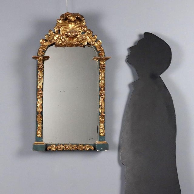 Carved and lacquered wood mirror from mid-19th century Italy. Features a masterfully crafted frame with leafy and floral...