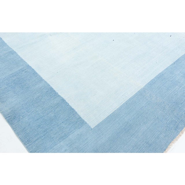 Vintage Indian Dhurrie Blue Rug. Size: 8'7" × 12'7" (261 × 383 cm) This vintage Indian Dhurrie rug is a masterclass in...
