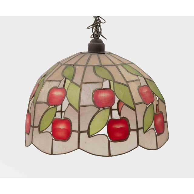 A decorative stained glass pendant chandelier, in the Tiffany revival taste of the mid-20th Century, featuring a domed...