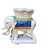 This is a vintage whimsical Palm Beach Style ceramic elephant plant stand. This charming elephant features a cream-colored...