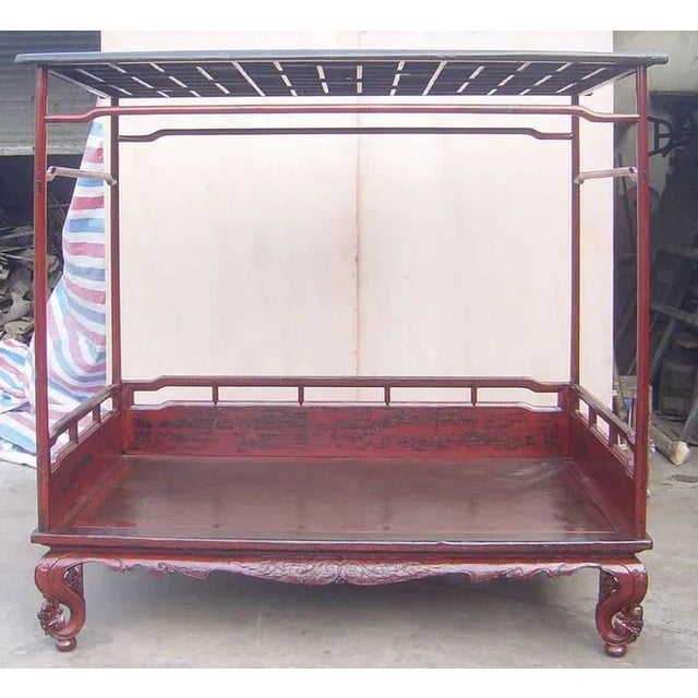 Wonderful 19th century Canopy Top Chinese Day Bed, Walnut worn red lacquer with inset rattan platform. Humpback struts,...