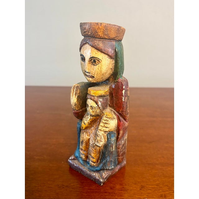 This devotional wood carving represents the Virgin of Montserrat, also known as La Moreneta (the Black Madonna), one of...