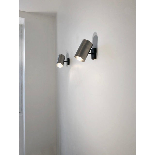 A fairly large pair of Post-Modernist, Seventies, Space-Age wall lights, in folded metal chrome on the outside, pearl...