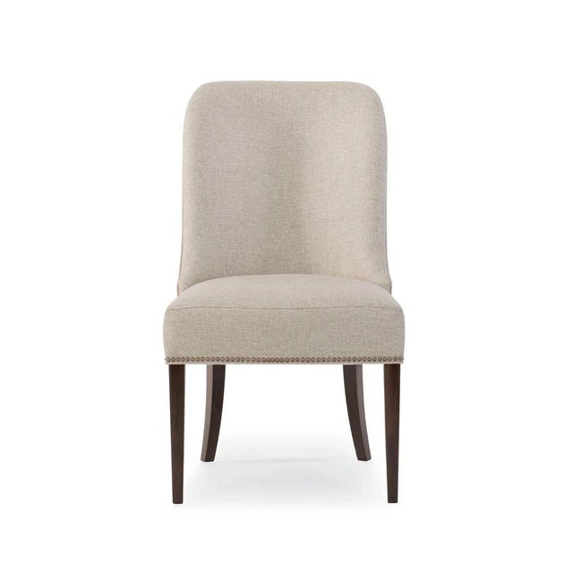 Clean, classic lines, fully upholstered in a neutral brushed fabric, with tapered sabre legs are finished in Bourbon...