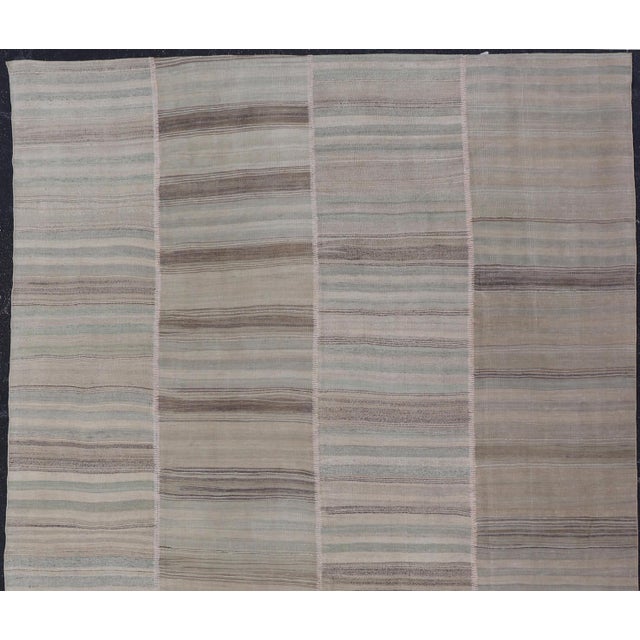Measures: 8'6 x 13'0 Vintage Turkish Kilim Rug in Soft Beige, Gray, and Faded Blue Striped 8'6 x 13'0. Keivan Woven Arts /...
