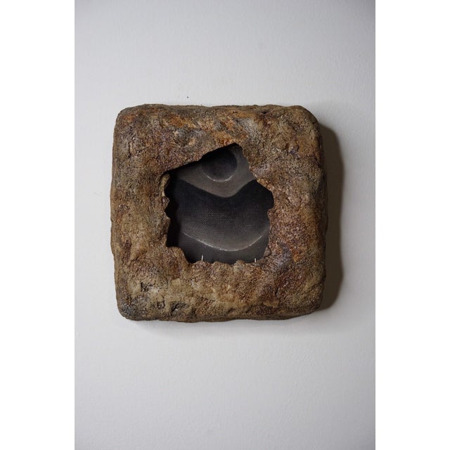 Excavation 1 presents a striking interplay between organic forms and industrial materials, featuring a textured, patinaed...