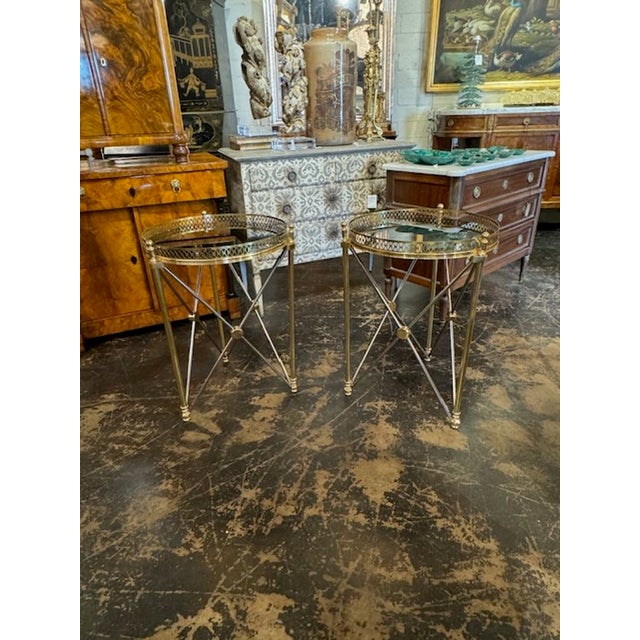 Fine pair of Jansen manner polished steel and brass side tables with black glass tops. A fine addition to any home!...