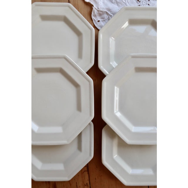 Elegant set of six white earthenware dessert plates by Johnson Brothers. Octagonal shape with a raised, beaded rim; clean...