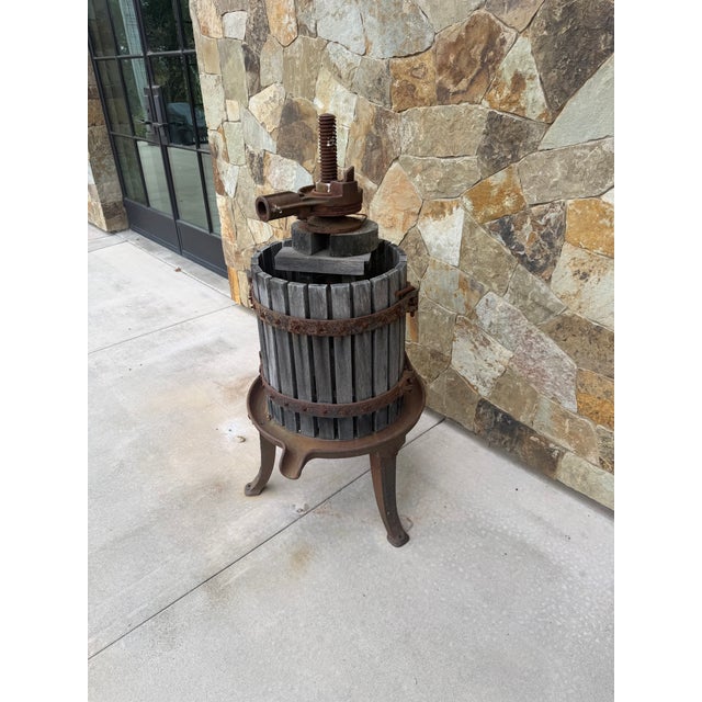 **Vintage Wood and Cast-Iron Grape Press** Rustic vintage grape press featuring a weathered wooden slat basket, iron...