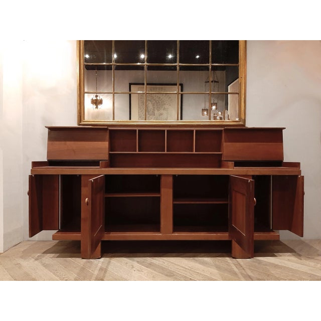 A midcentury Italian buffet cabinet designed by Silvio Coppola for Bernini. This walnut cabinet features two end doors...