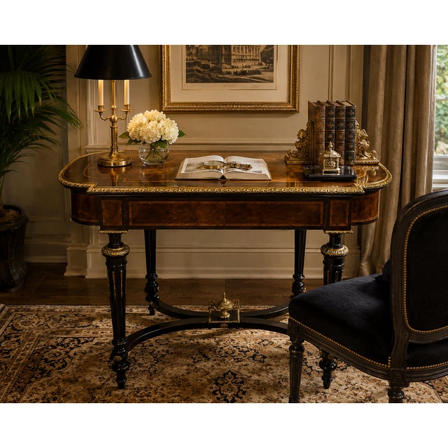 Elegant vintage French Neoclassical style writing desk featuring richly figured burlwood veneers, dramatic ebonized legs,...