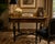 Elegant vintage French Neoclassical style writing desk featuring richly figured burlwood veneers, dramatic ebonized legs,...