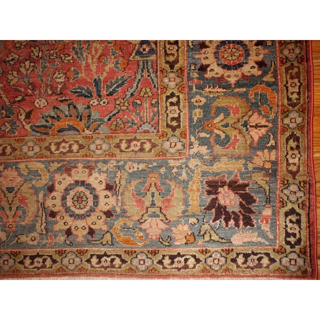 Fine weaved Indian Loristan rug in peach and coral colours. Garden design all over the rug with greyish-blue details. It...